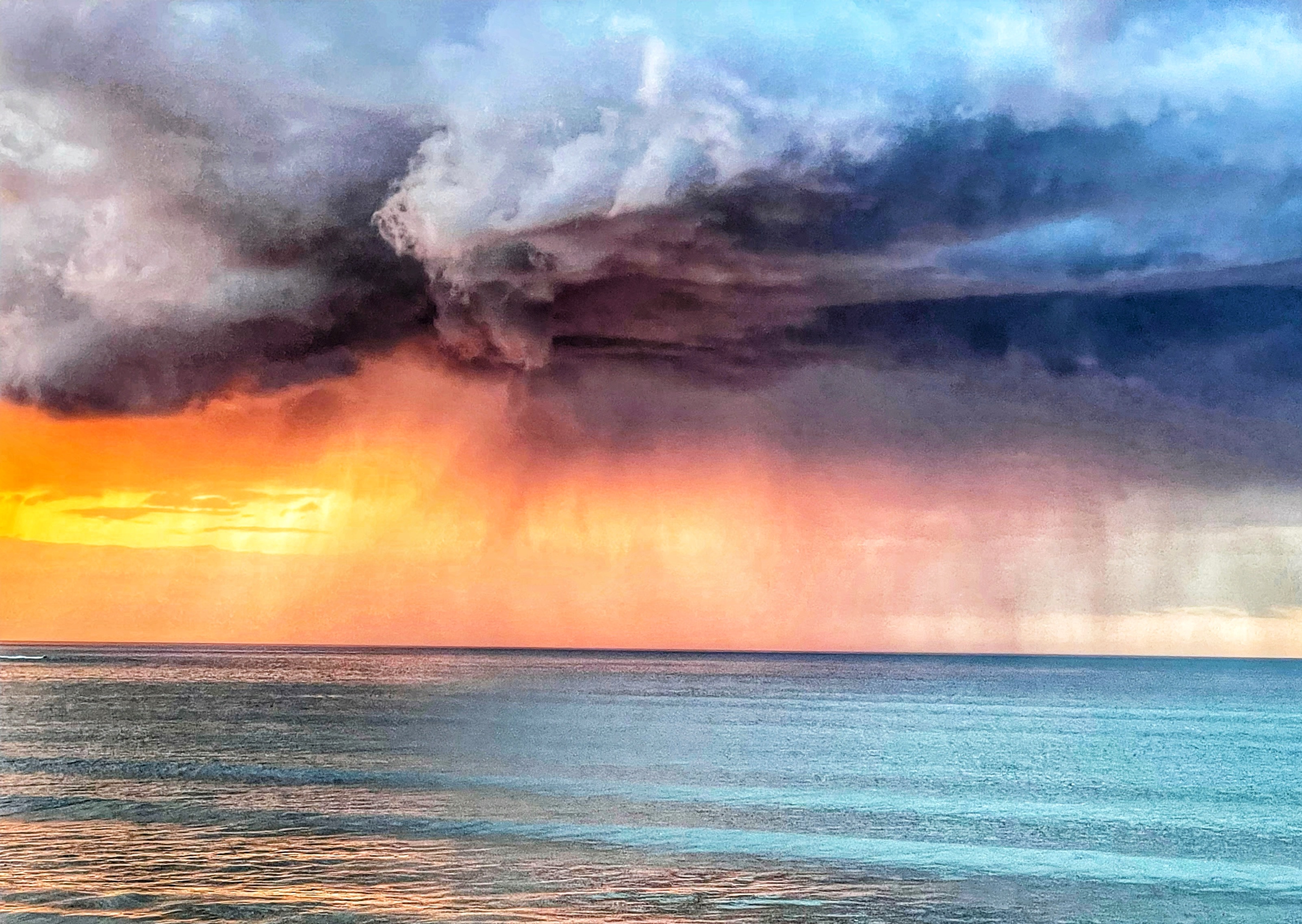 Photo of sunset with rain falling