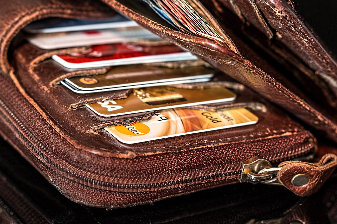 a brown worn out wallet showing a few cards in the card slots