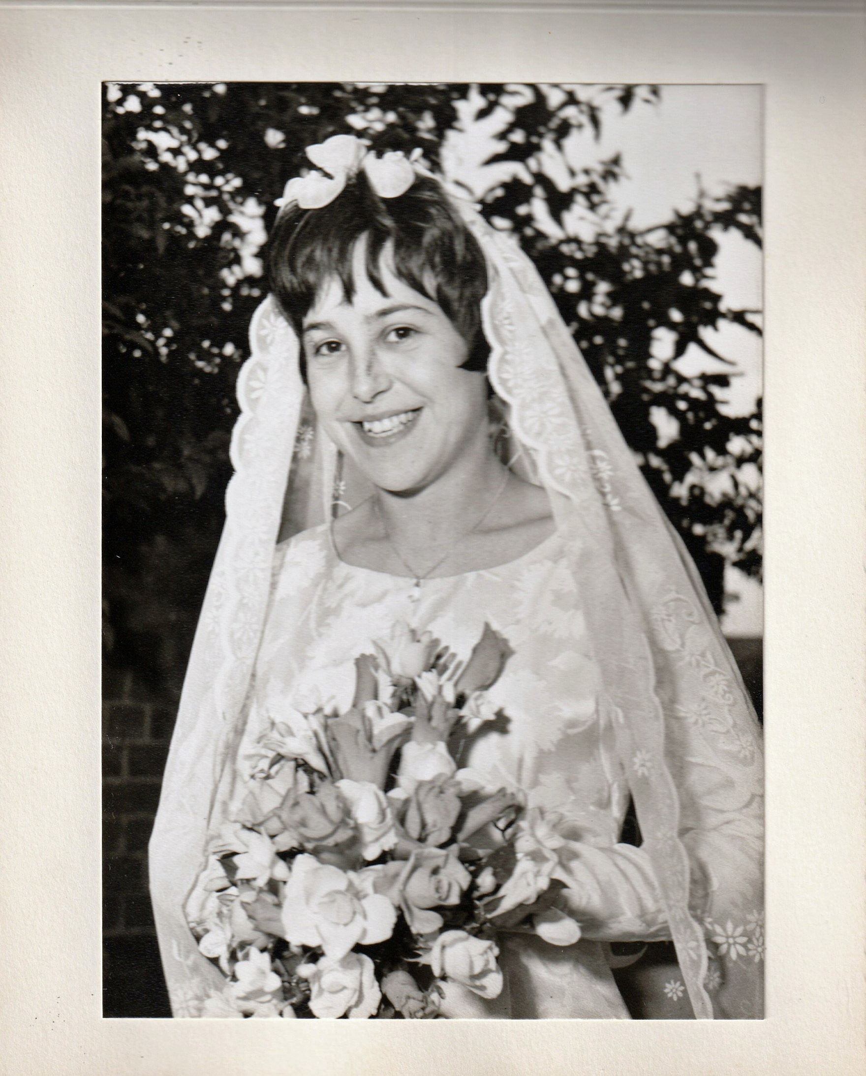 black and white photo of a woman smiling at her wedding