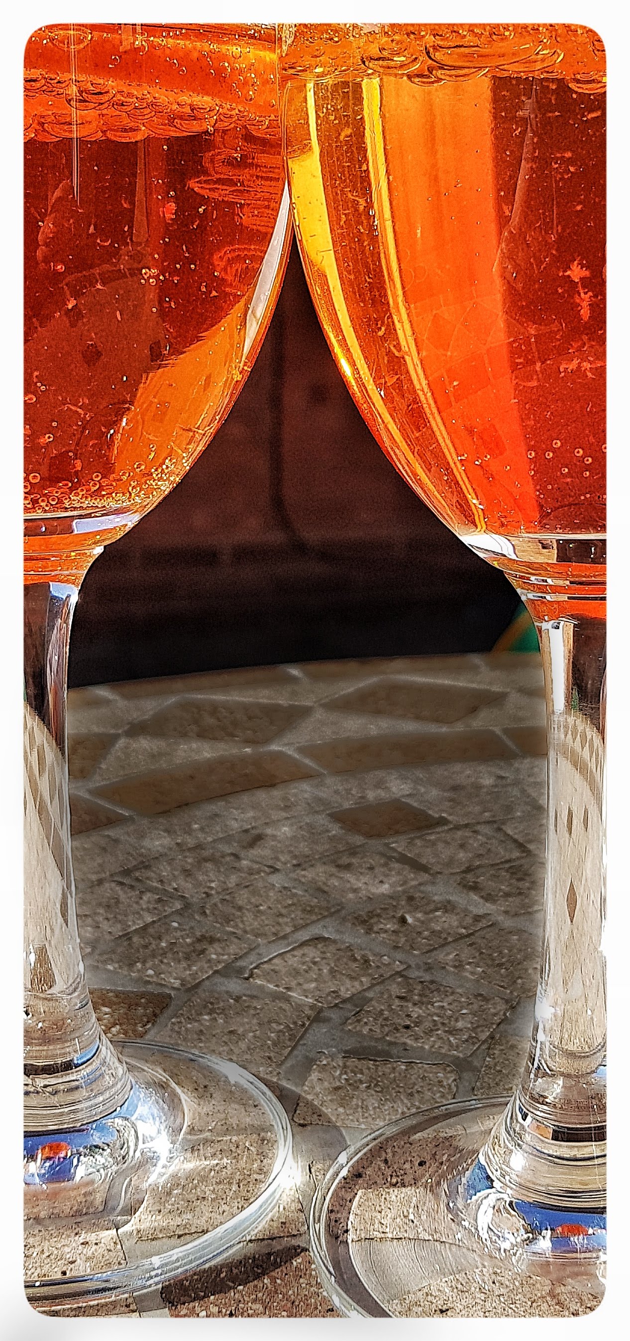 Close up image of wine glasses with Aperol