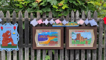 knitted pictures of a beach and castle