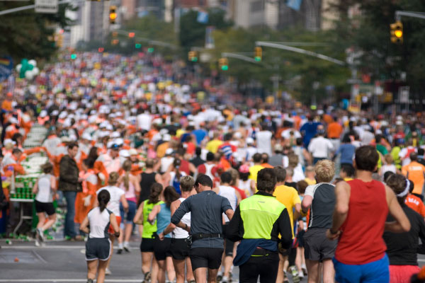 A road filled with runners running a half marathon