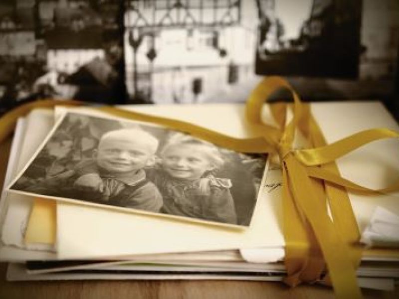 black and white photo of young children on an old fashioned pile of letters 