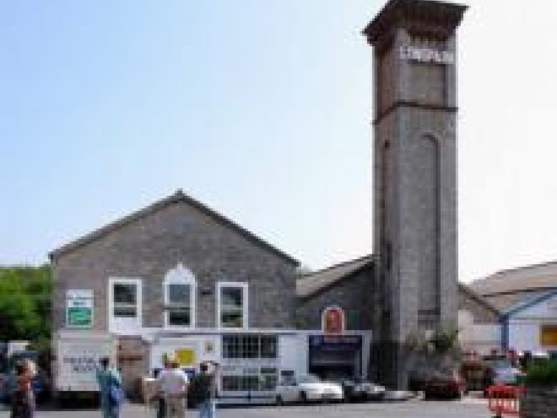 a stone building with a tall tower, on a sunny day